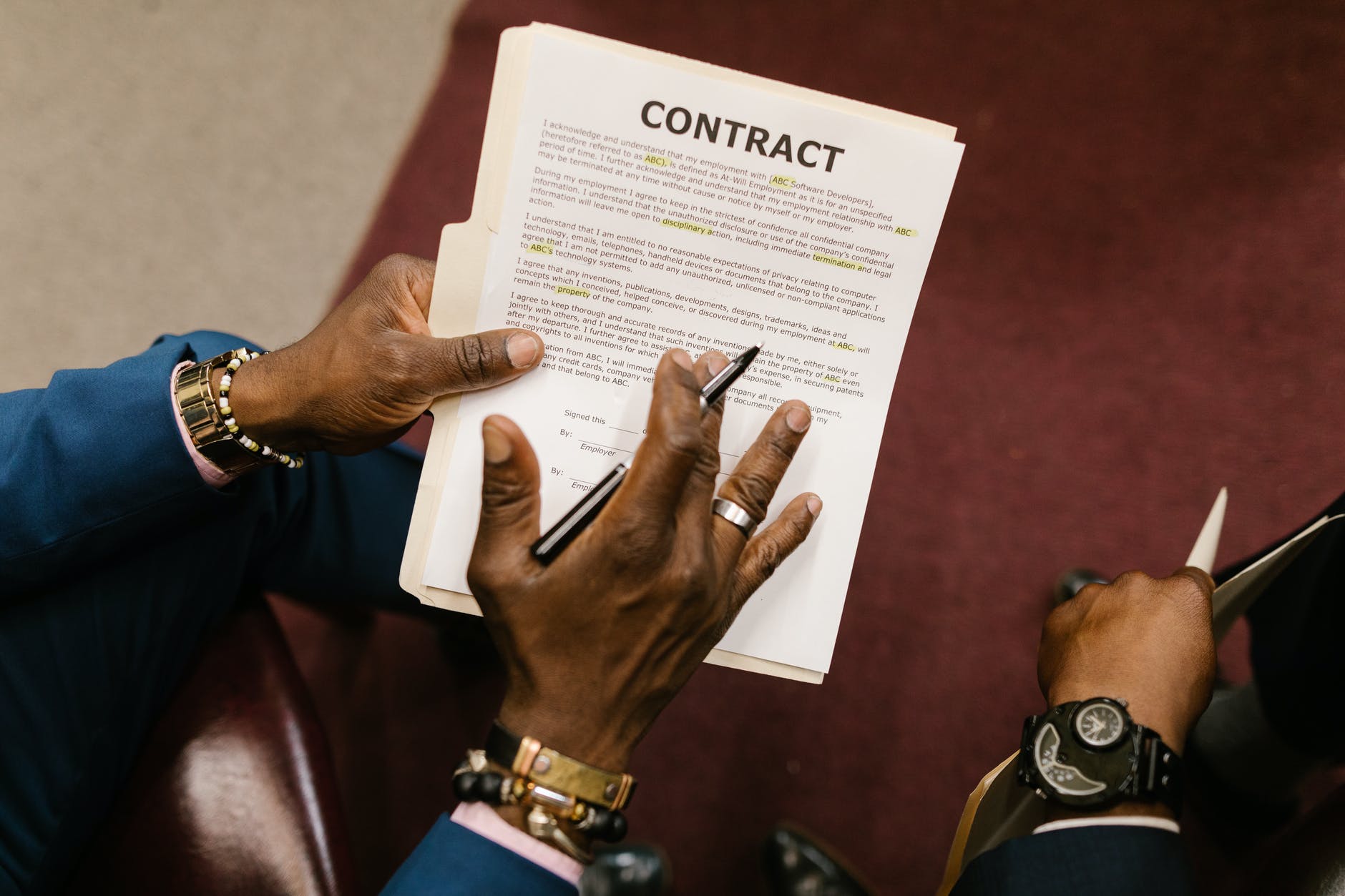 man handing over highlighted contract